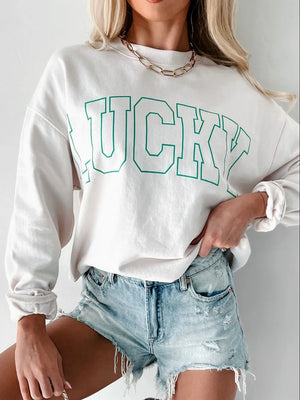 White sweatshirt with green varsity "LUCKY" graphic and crew neck