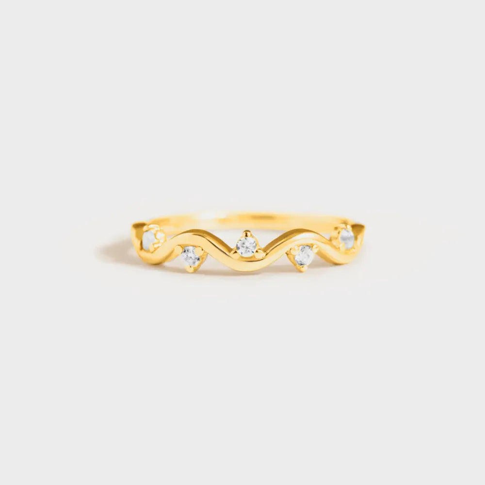 Gold wavelet ring with small clear stones