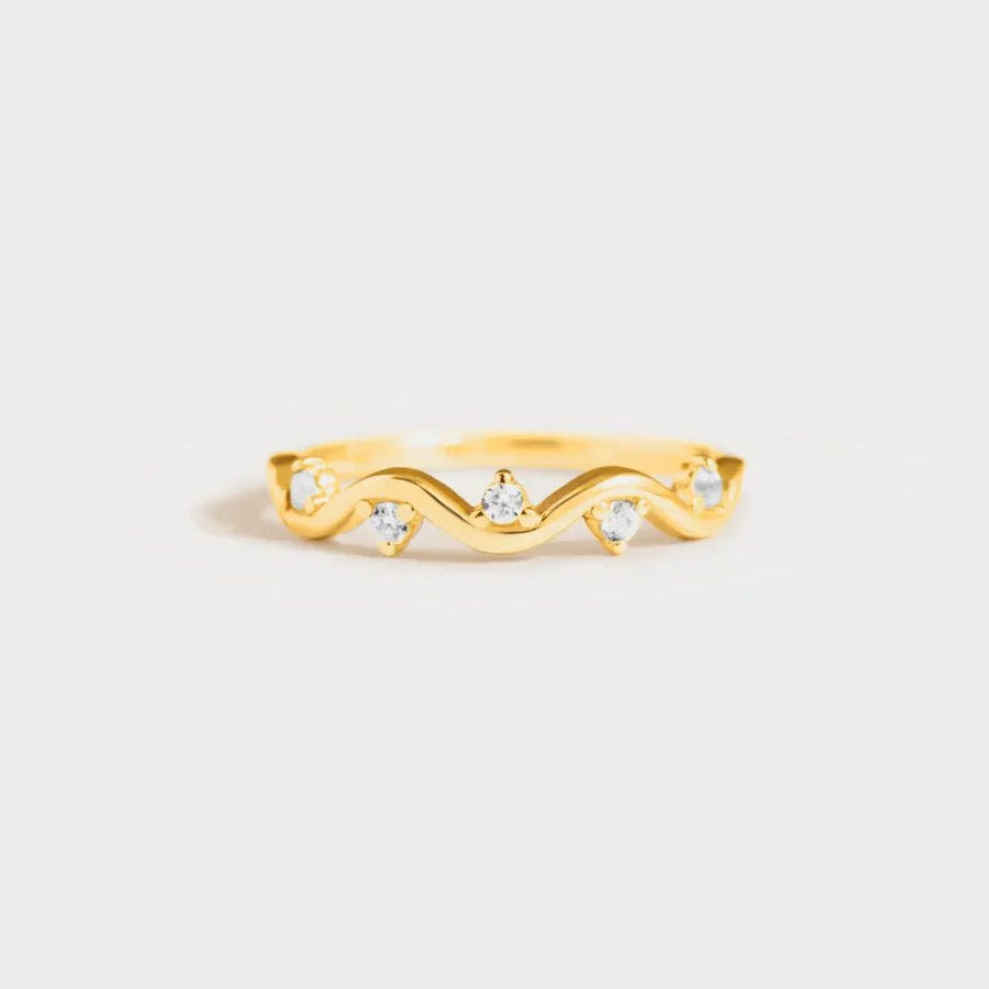 Gold wavelet ring with small clear stones