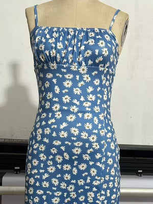 Sky blue spaghetti strap midi dress with white daisy print and ruched bust.