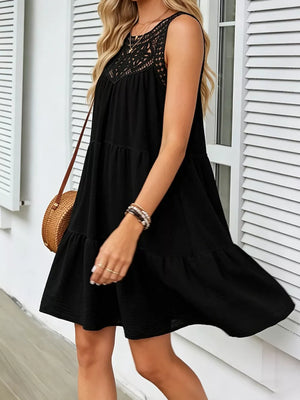 Black tiered dress with lace neckline detail, sleeveless, casual mini length.