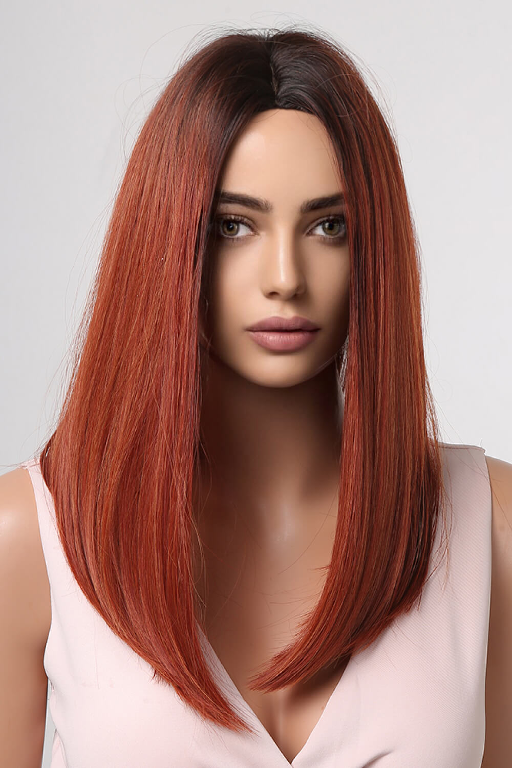 Auburn ombre wig with dark roots and straight, shoulder-length hair styled with a center part.