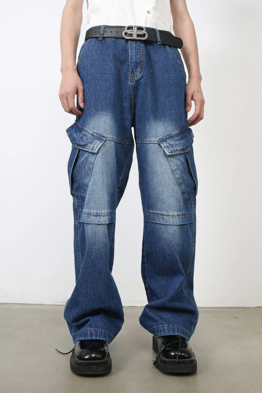 Medium wash denim cargo flare trousers with multiple pockets and a faded wash.