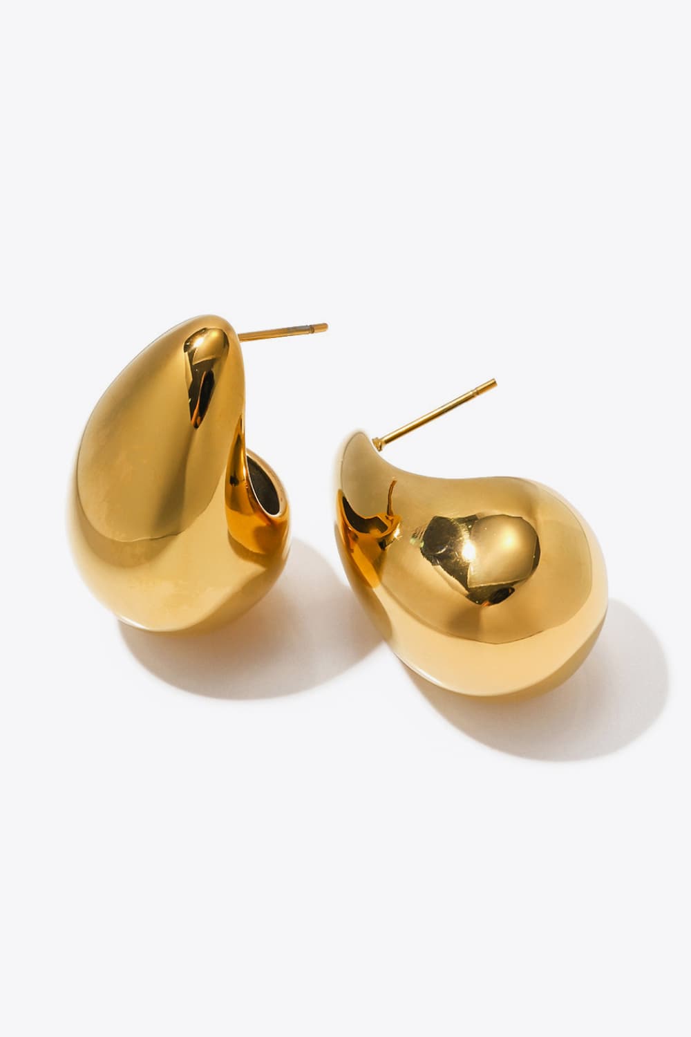 Sculptural gold teardrop stud earrings with a polished finish.