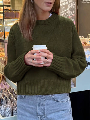 Army green ribbed round-neck knit sweater with long sleeves and a comfortable fit.
