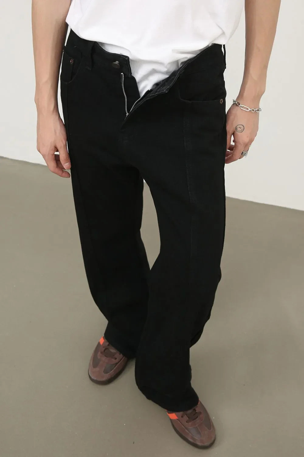 Black panel seam flare jeans with a zipper fly and a relaxed fit.