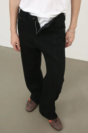 Black panel seam flare jeans with a zipper fly and a relaxed fit.