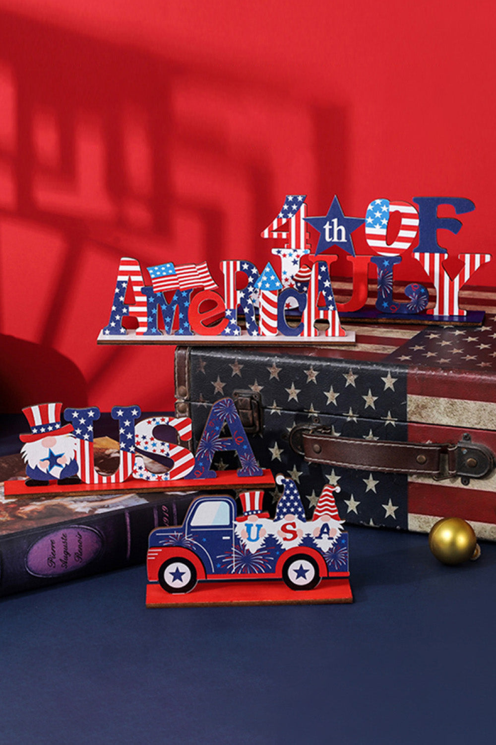 Patriotic wood block decor with AMERICA and 4th of July text, featuring gnomes and a truck.