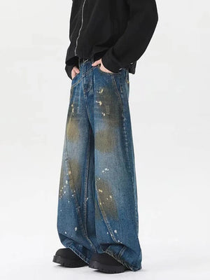 Men's plus-size wide-leg jeans in washed blue denim with paint splatter details.