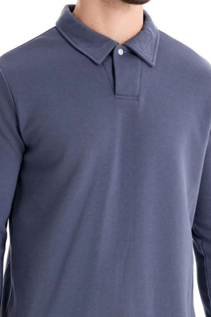 Dusty blue long sleeve polo shirt with collar detail and button placket.