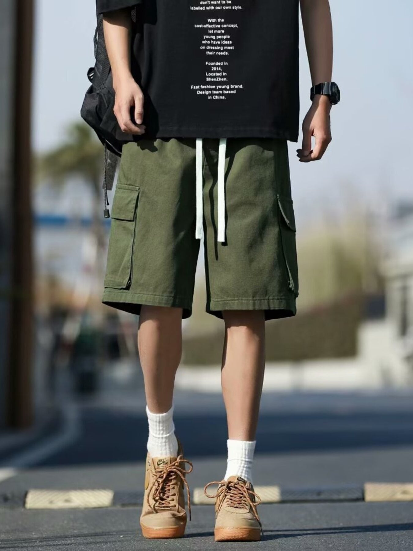 Men's green casual cargo shorts with drawstring and multiple pockets.