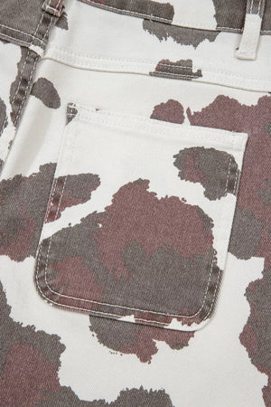 Cow print utility jeans with a visible cargo pocket detail.