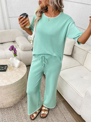 Light green loungewear set with crew neck top and drawstring pants, white piping detail