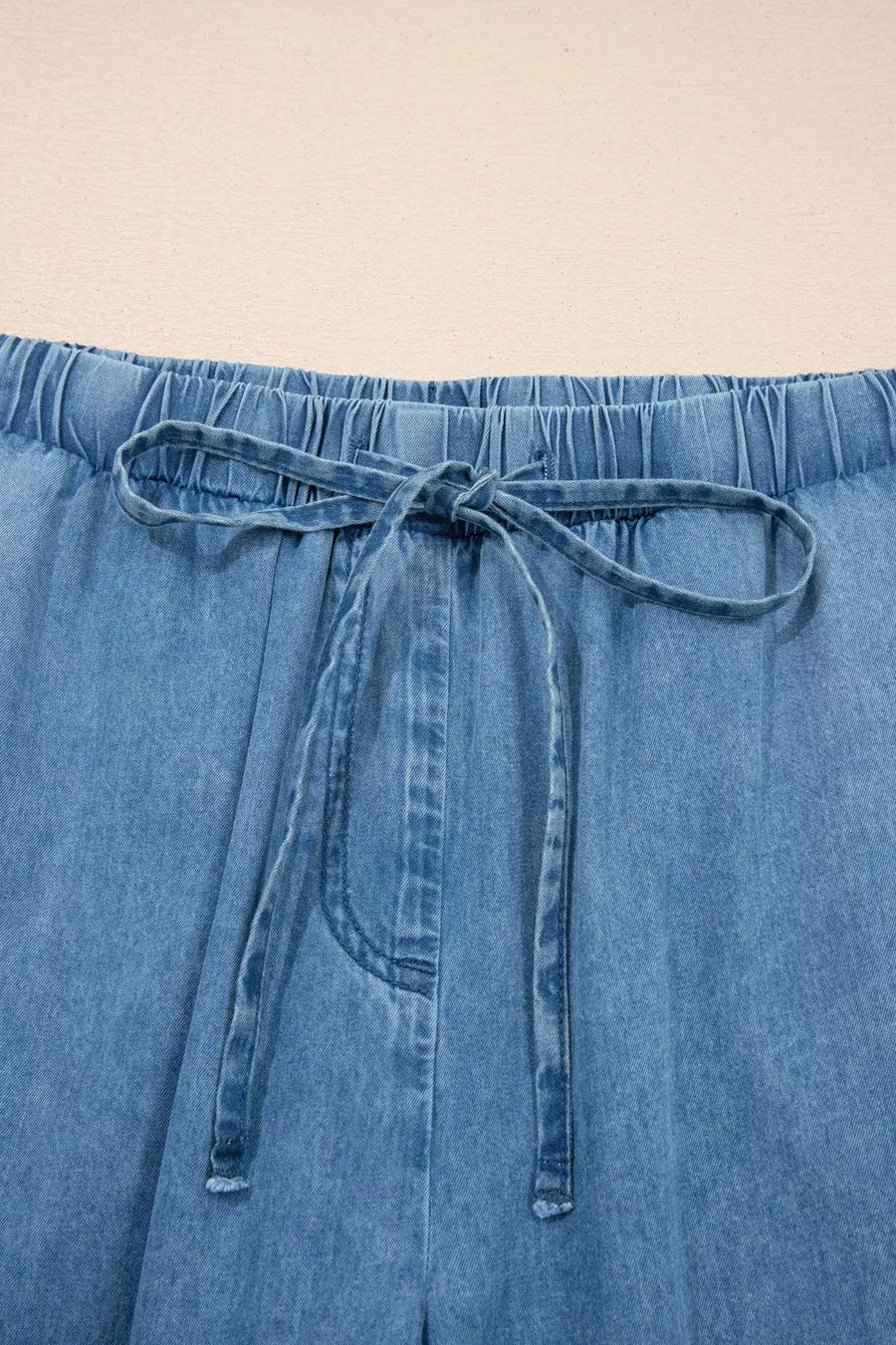 Maternity wide-leg jeans in light wash denim with elastic waistband and drawstring tie.