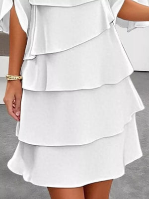White ruffled layered flutter sleeve dress with a tiered skirt.