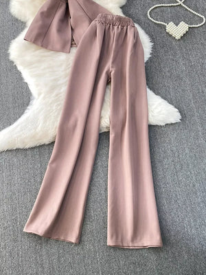 Dusty pink belted two-piece set with pockets, featuring wide-leg pants and a cropped jacket.