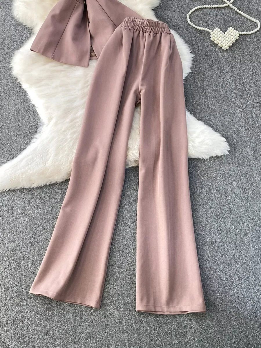 Dusty pink belted two-piece set with pockets, featuring wide-leg pants and a cropped jacket.