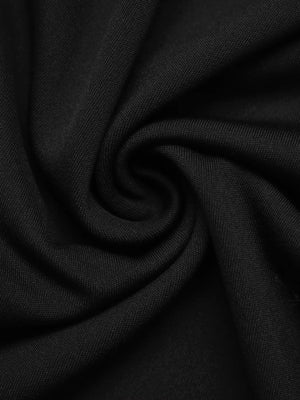 Black midi skirt with button front detail and textured fabric.
