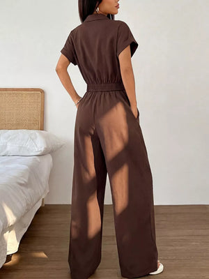 Brown wide-leg jumpsuit with short sleeves, collared neckline, elastic waist, and pockets.