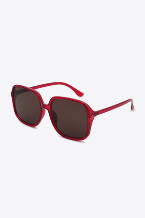 Red square frame sunglasses with dark lenses and bold acetate frames.