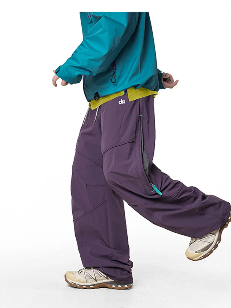 Relaxed fit cargo pants in Meadow Purple with drawstring and zippered pockets.