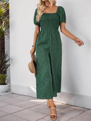 Green leopard print smocked bodice jumpsuit with puff sleeves and wide legs.