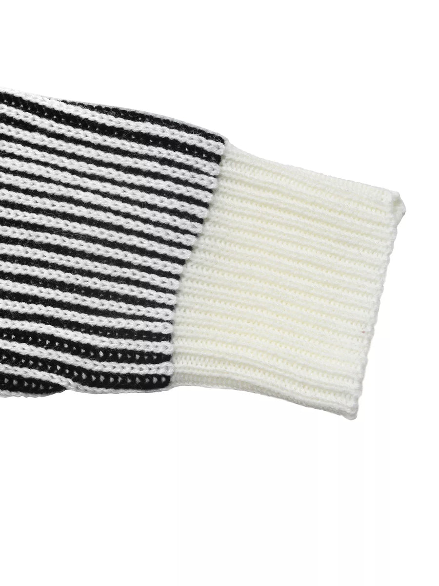 Black and white striped knit sweater with a white ribbed cuff and sleeve detail.
