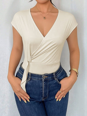 Elegant cream surplice bodysuit with cap sleeves and tie waist detail