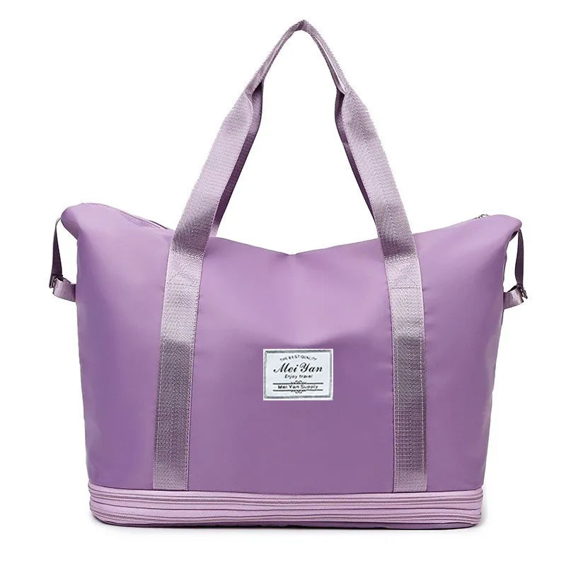 Expandable travel tote in plum purple with contrast trim and dual straps.