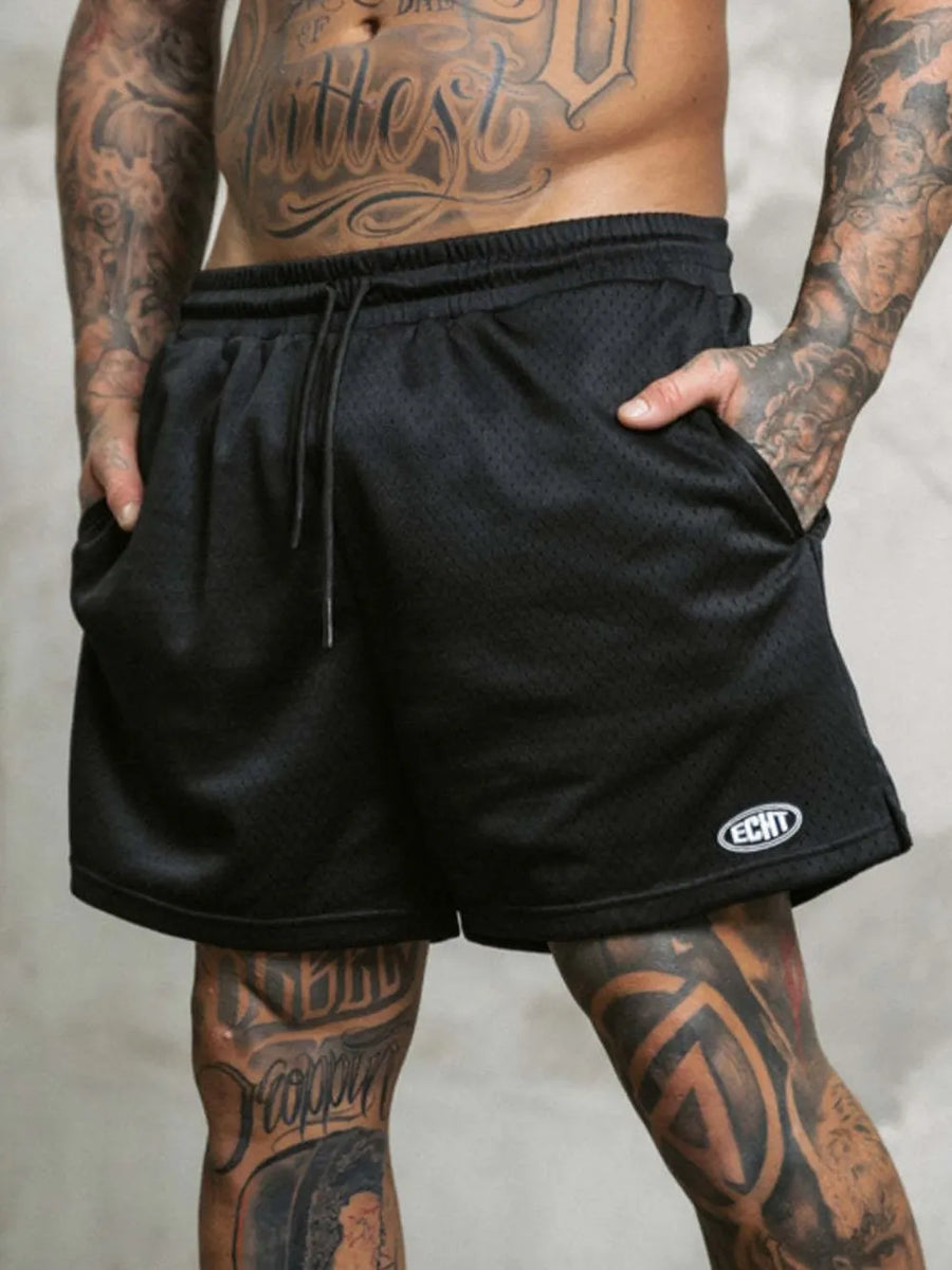 Black perforated performance drawstring shorts with side pockets and a small logo detail.