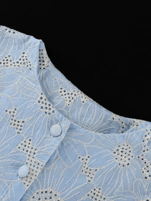 Light blue cotton eyelet top with white floral embroidery and button detail