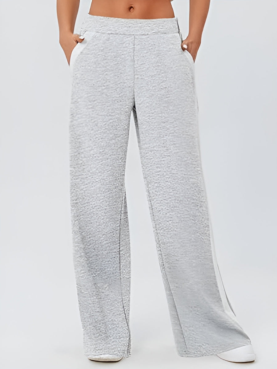 Light gray palazzo trousers with contrast white side panels and textured fabric.