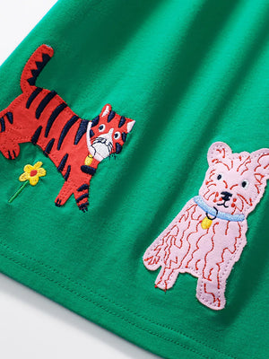 Green cotton toddler dress with embroidered tiger and dog appliques.