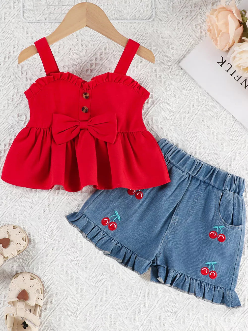 Red ruffle-trim top with bow and cherry embroidered denim shorts set