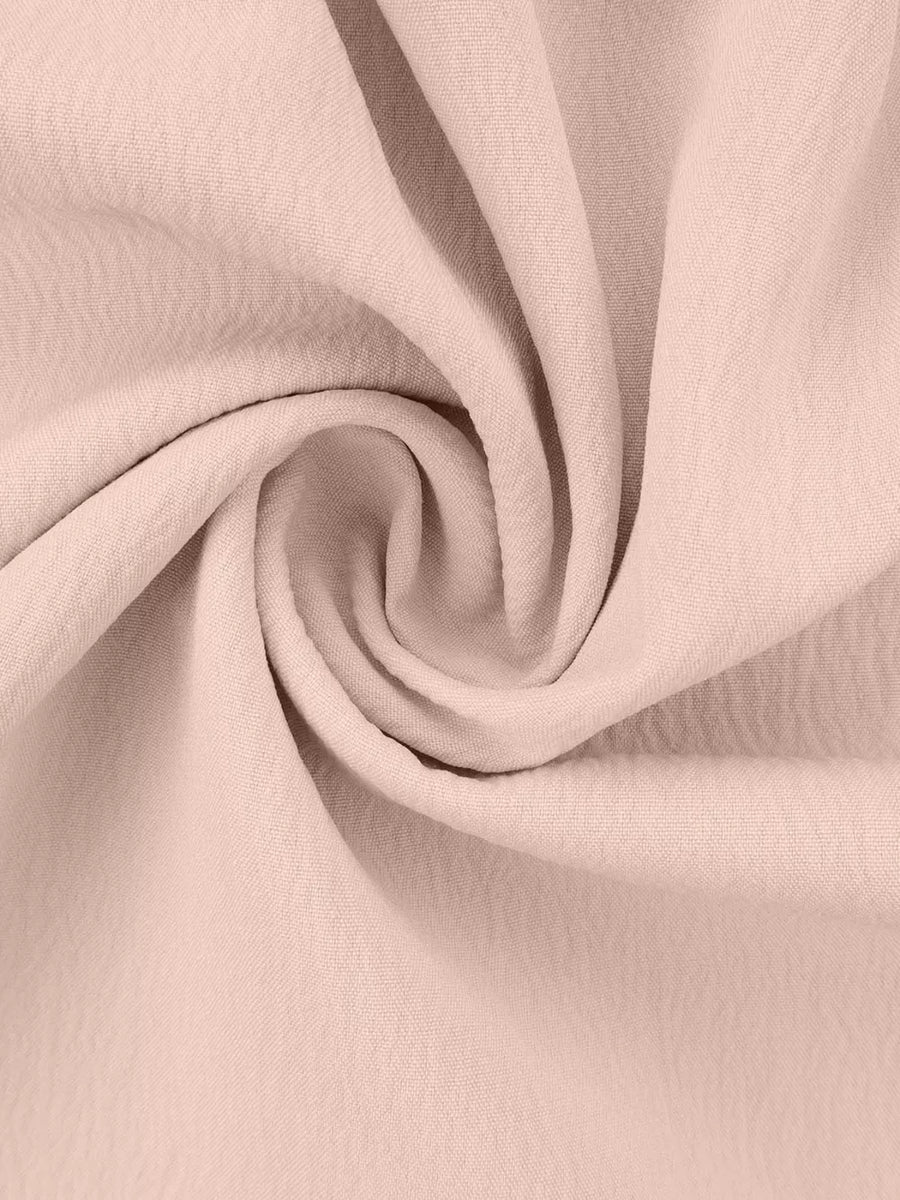 Pale blush polyester pajama fabric with ruffled texture