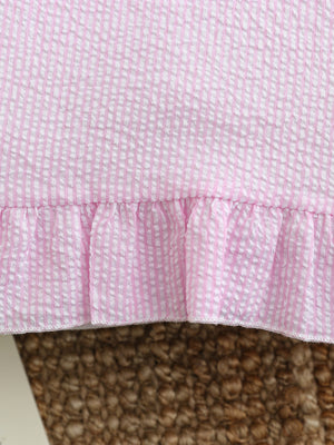 Pink and white seersucker baby dress with ruffled hem detail