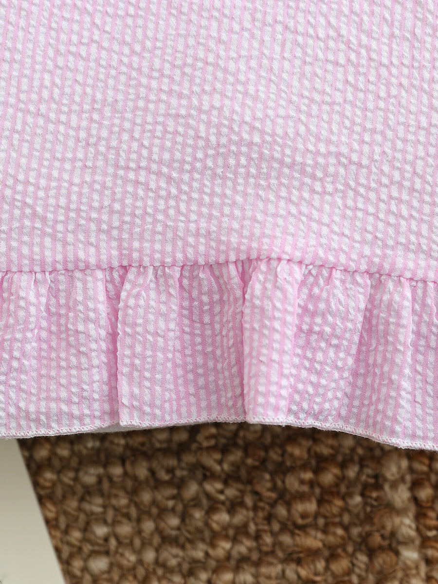 Pink and white seersucker baby dress with ruffled hem detail