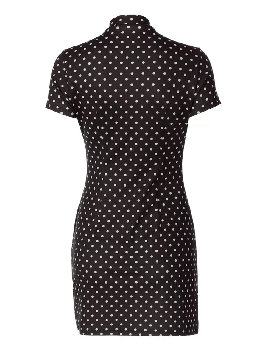 Black polka dot mini dress with short sleeves and a mock neck.