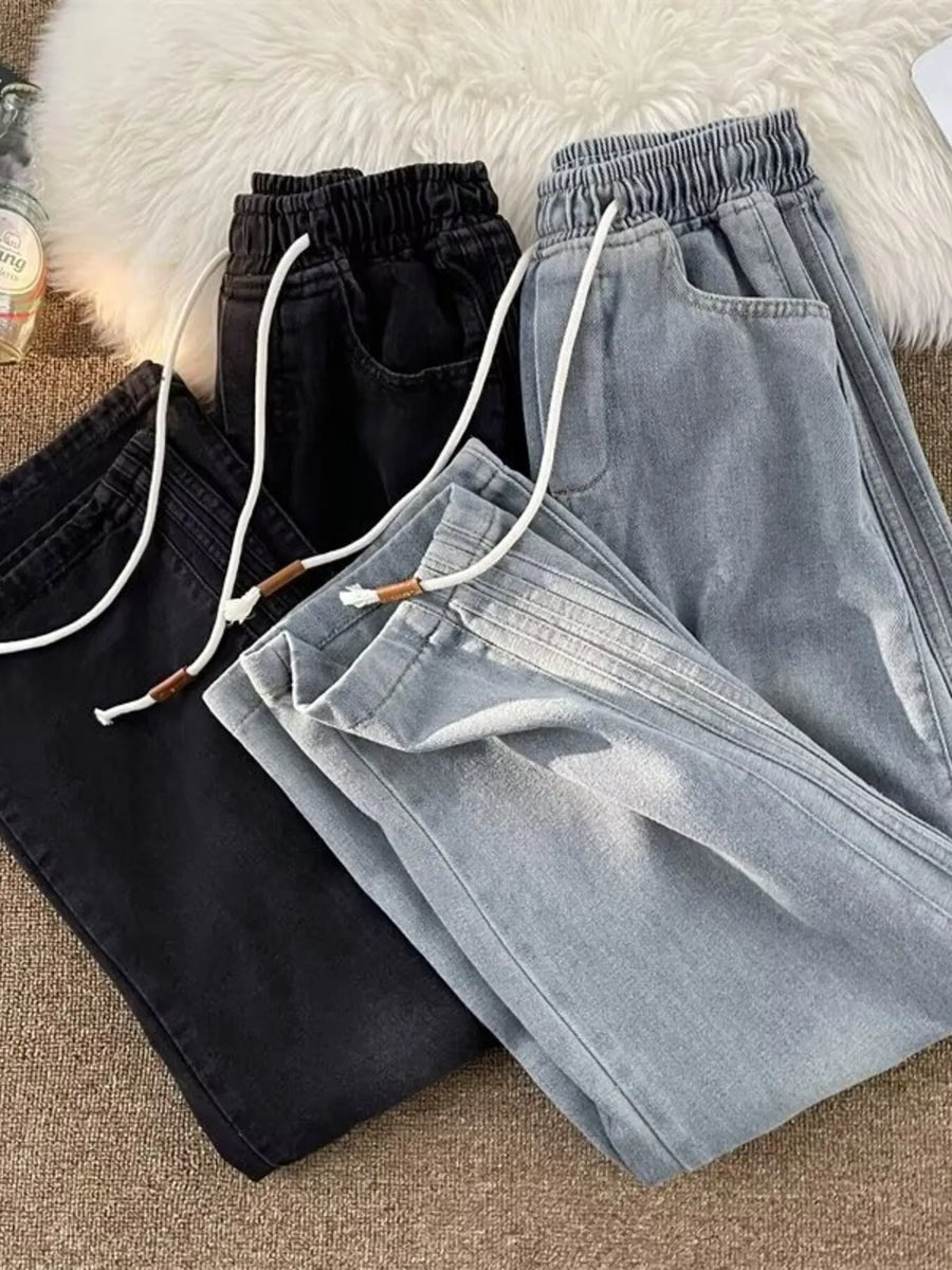 Men's wide-leg jeans in black and blue with drawstring waist and pockets.