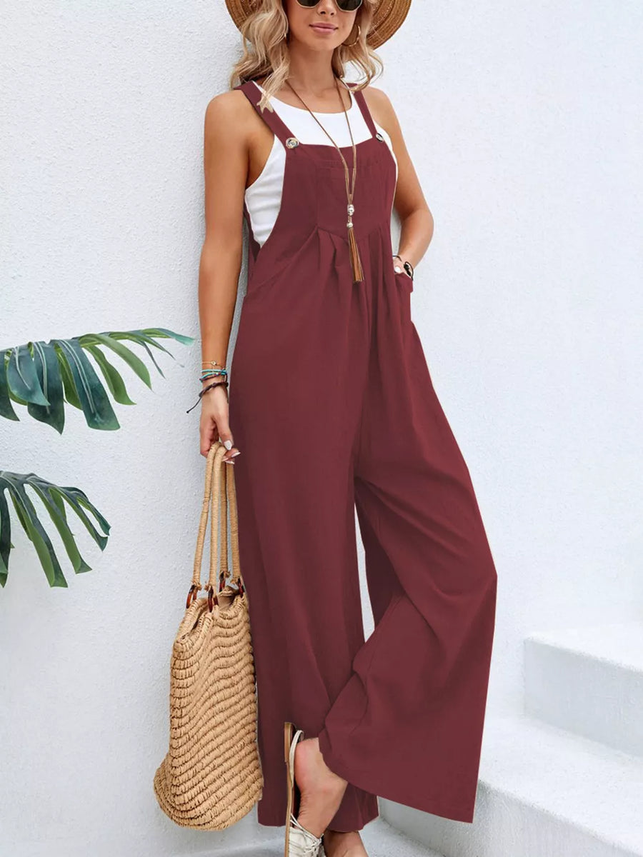 Burgundy wide-leg romper with pockets and buttoned straps, styled with a white tank.
