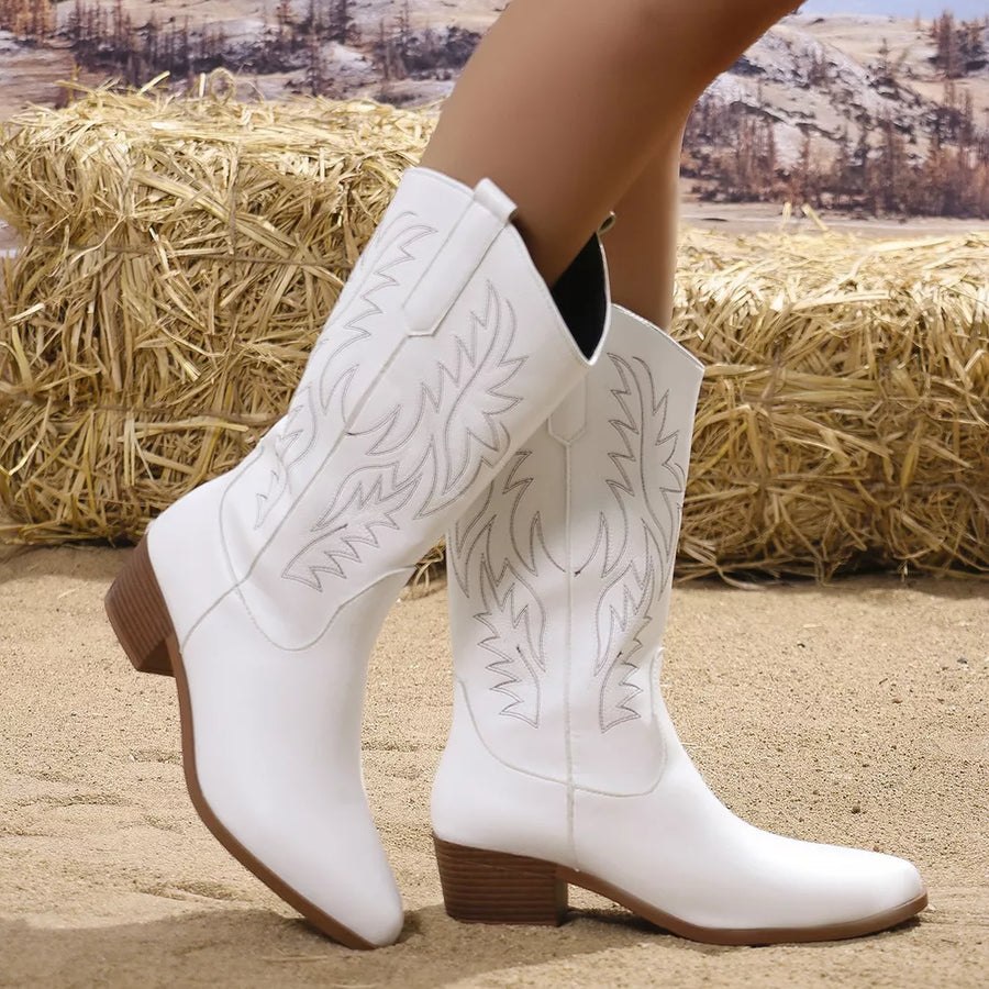 White embroidered mid-calf western boots with block heels and a pointed toe.