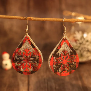 Plaid snowflake drop earrings in deep red with glitter accents.