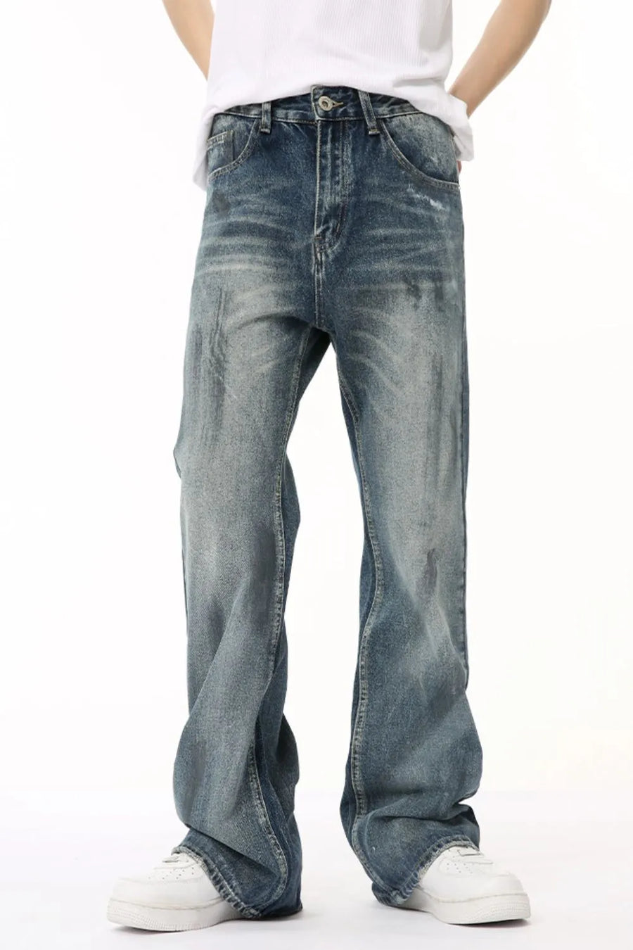 Baggy distressed denim flare jeans in medium wash, featuring a relaxed fit and faded details.