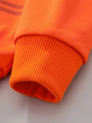 Orange children's sweatshirt cuff with ribbed detail and dark stripes on sleeve.