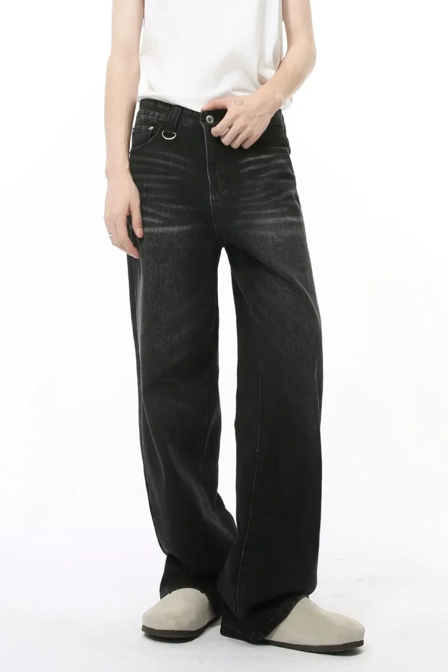 Dark wash denim jeans with wide legs and statement pockets.