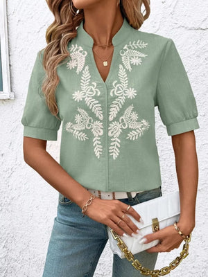 Green embroidered notched blouse with cuffed sleeves and V-neck.