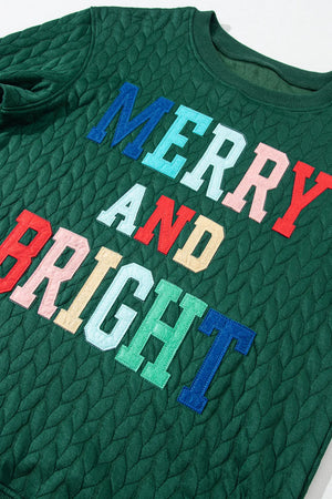 Dark green textured sweatshirt with "Merry and Bright" applique letters.