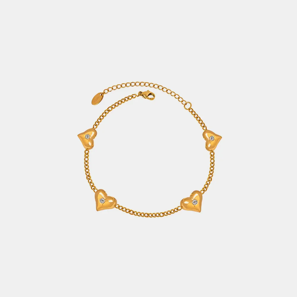 Gold chain bracelet with five diamond-accented heart charms.