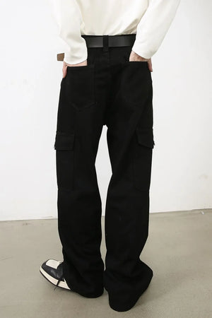 Black denim cargo pants with pleated details and multiple pockets.