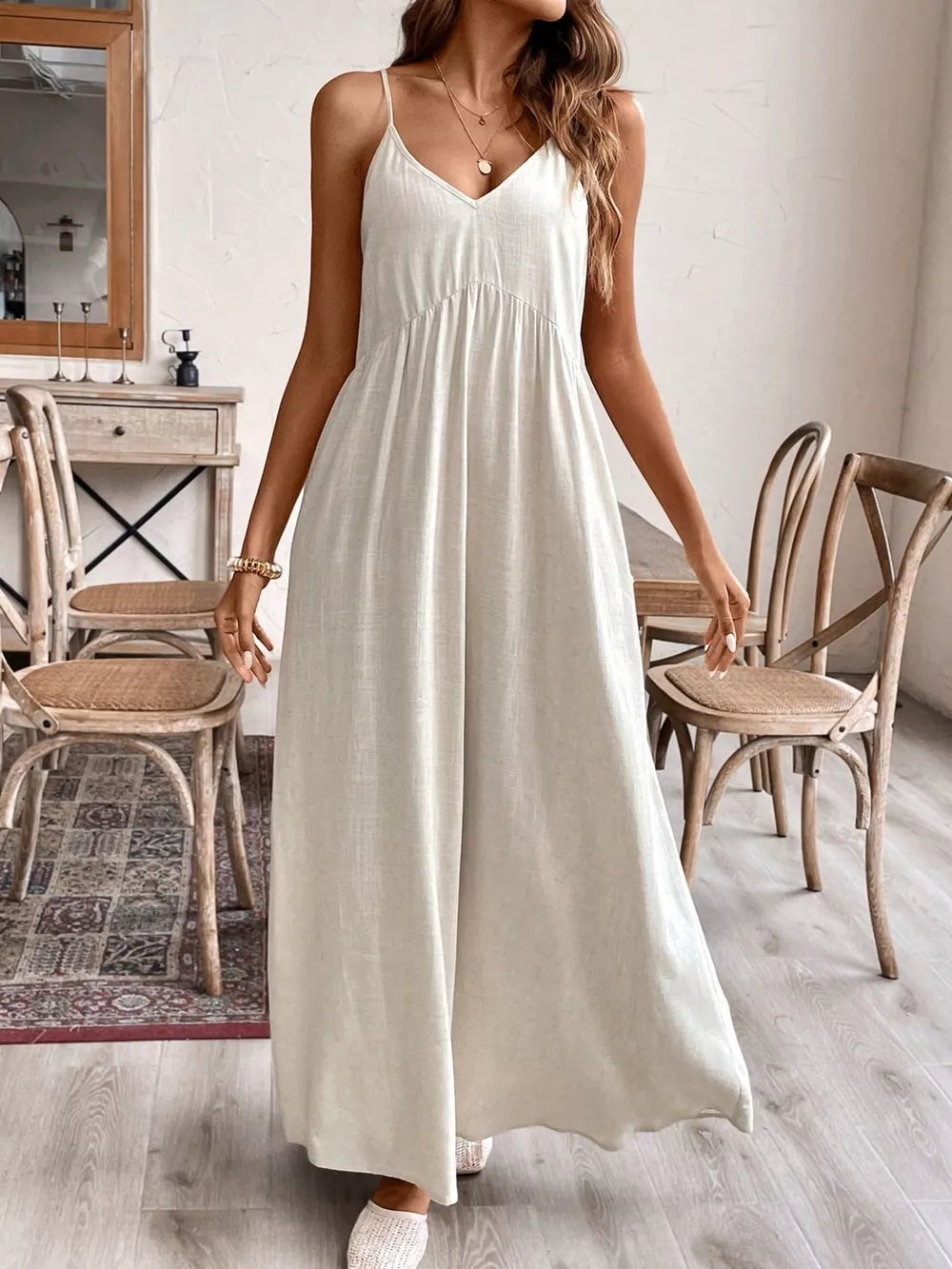 Effortless V-neck maxi dress in natural linen, with spaghetti straps and a gathered waist.